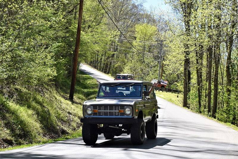 Dark green Bronco on the road