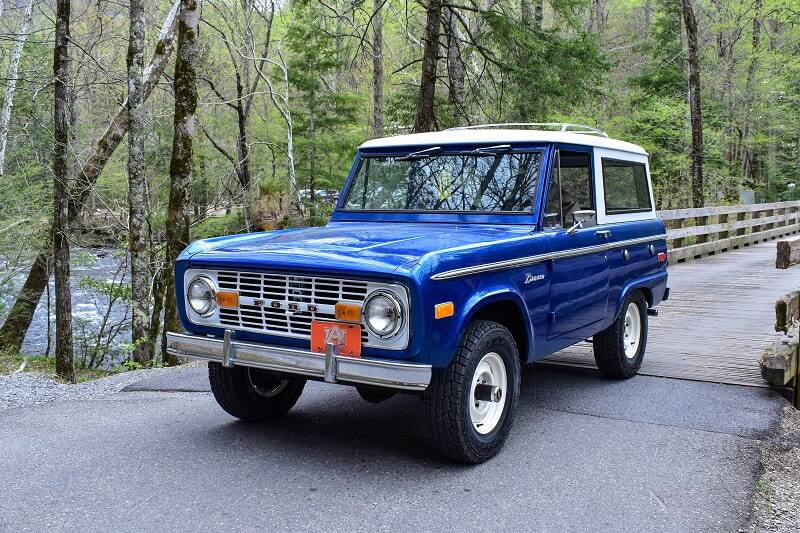 Blue Bronco drop top over wooden bridge