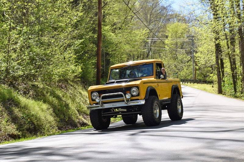 Yellow Bronco drop top on the road