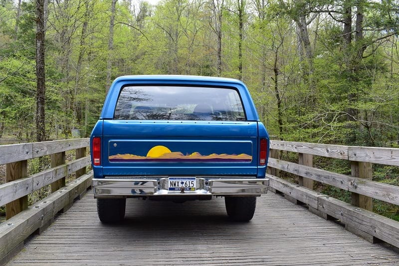 Rear of blue Bronco on wooden bridge