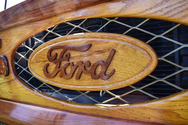Close up of Ford logo on front of wooden styled Bronco