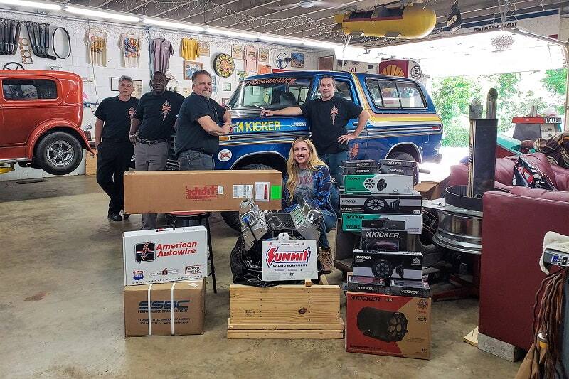 Team Bronco Girl in front of blue Bronco in garage