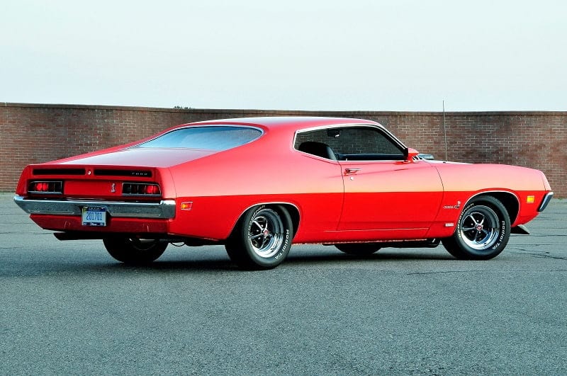Rear profile of red Torino Cobra in parking lot