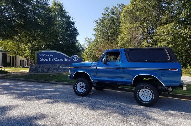 Profile of blue Bronco in front of South Carolina sign