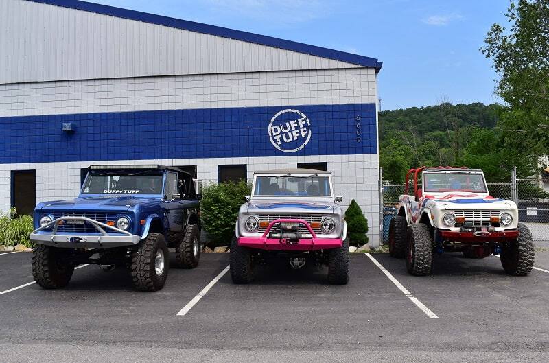 Three broncos are pictured in front of Duff Tuff garage building