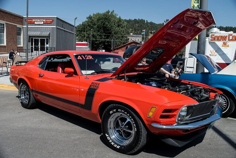 Front profile of red Mustang Boss 302 with hood up