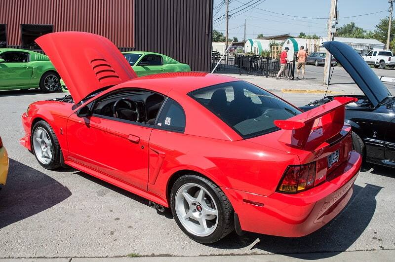 Rear of red Shelby Mustang with hood up