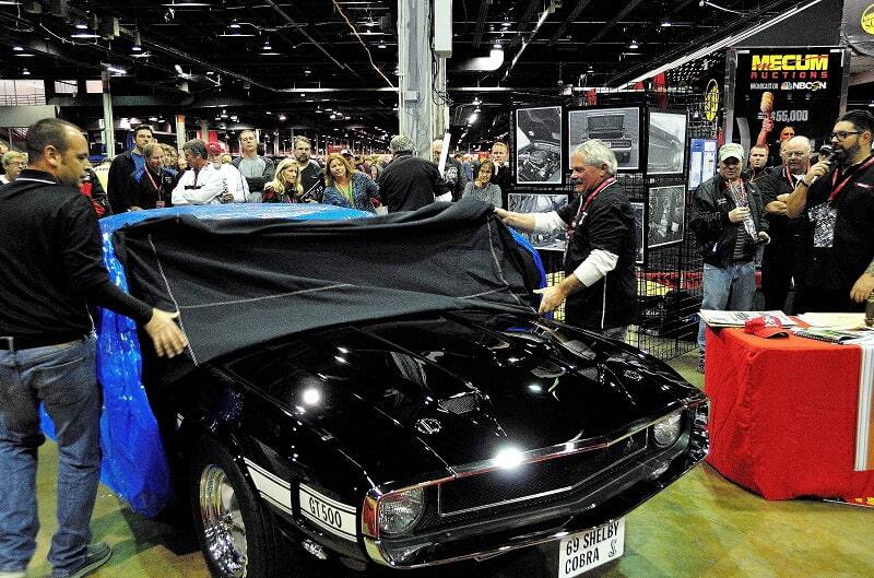 Men uncovering black Shelby GT