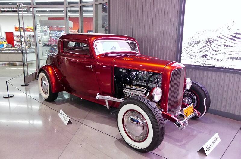 Front profile of a red Ford Coupe on display