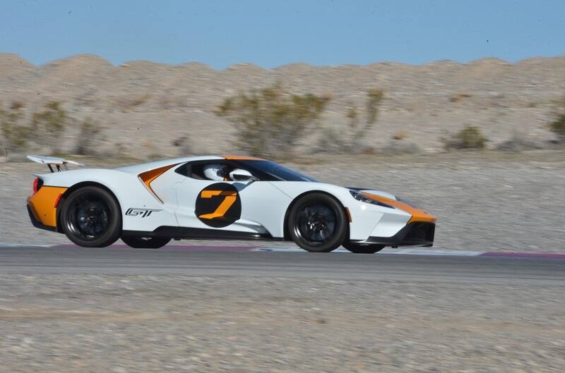 Profile of a white orange and black GT driving on the track