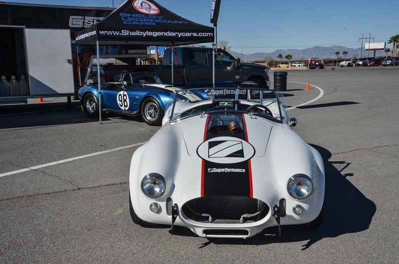 Front of white Shelby Roadster with blue Roadster behind it