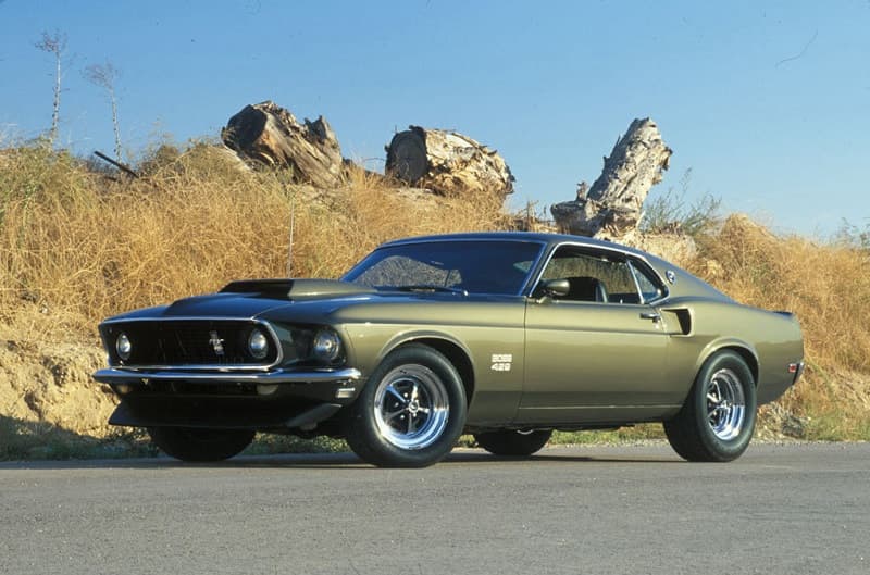 Front profile of a green Boss 429 Mustang on the side of the road