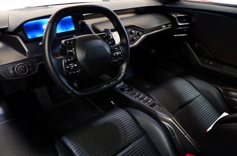 Interior close up of front seat with steering wheel and dashboard