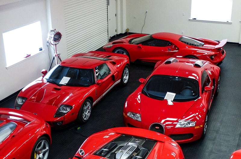 Overhead shot of various red Fords in a garage