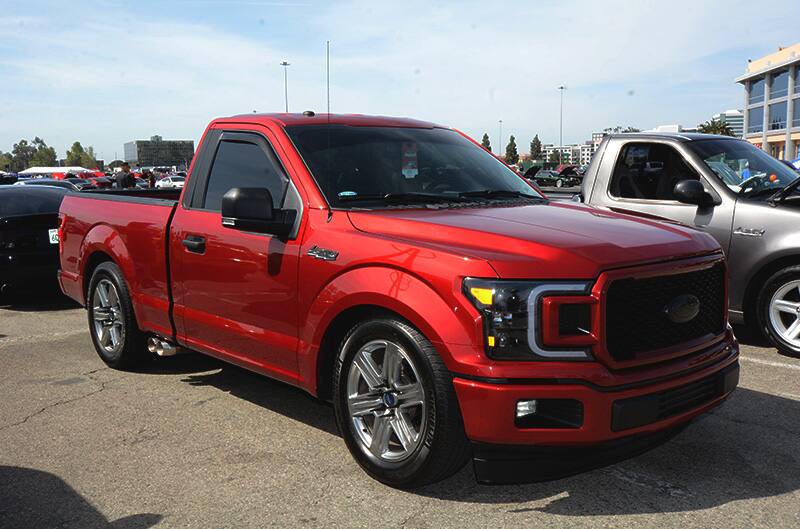 Front profile of red F150 in parking lot