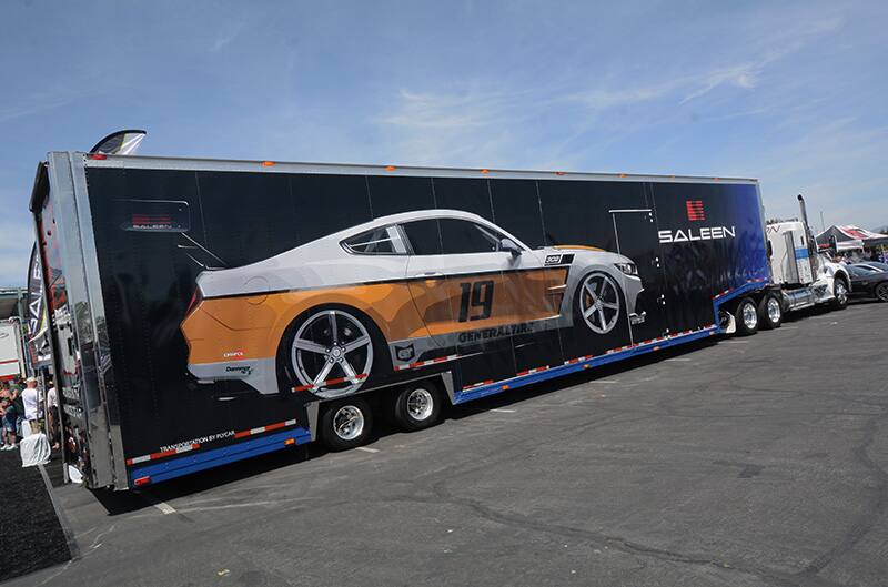 Profile of semi truck with a white and orange Saleen painted on the side