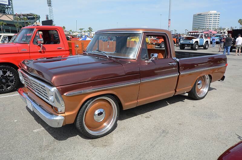 Front profile of a dark orange Ford truck in parking lot