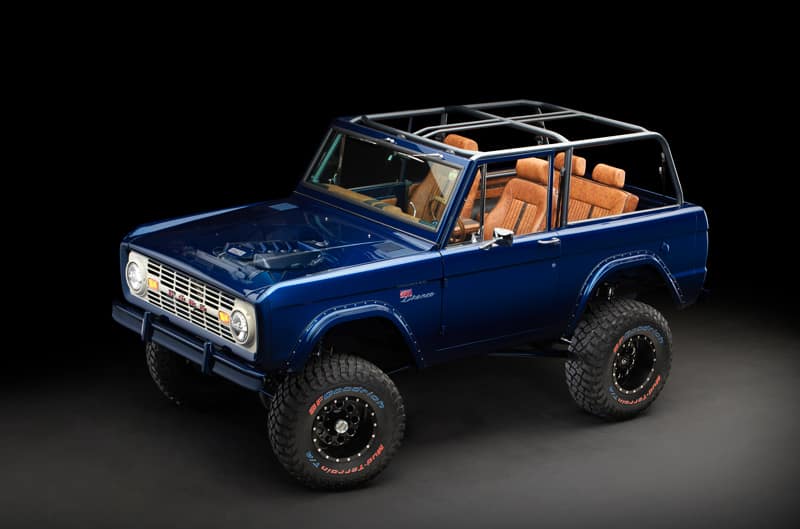 Front profile of blue Bronco with windows and roof off