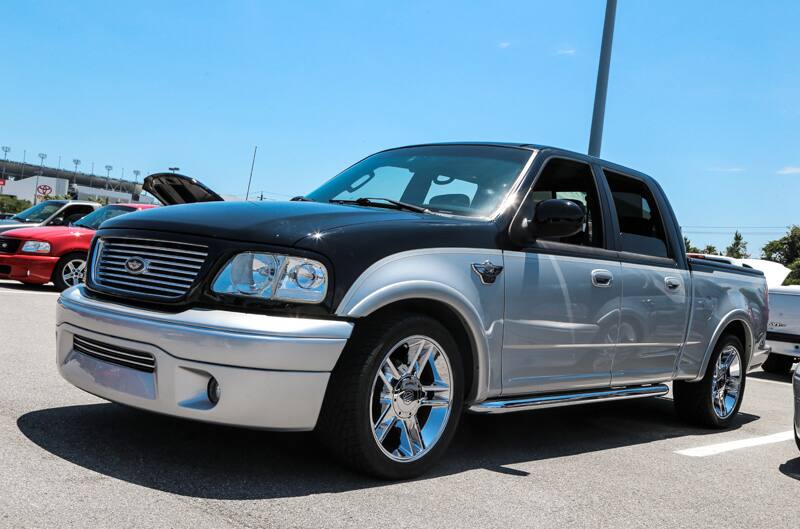 Front profile of black and silver SVT Lightning pickup in parking lot