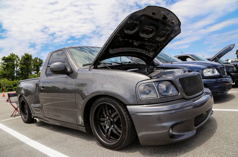 Front of gray SVT Lightning with hood open in parking lot