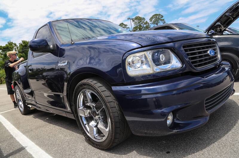 Close up front profile of navy blue SVT Lightning in parking lot