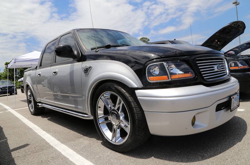 Front profile of black and silver SVT Lightning in parking lot