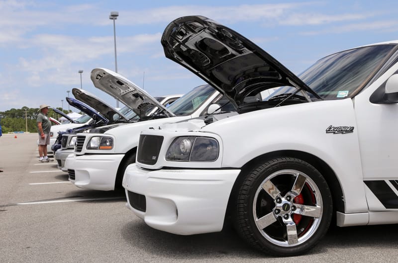 Close up front profiles of various white SVT Lightnings in a parking lot