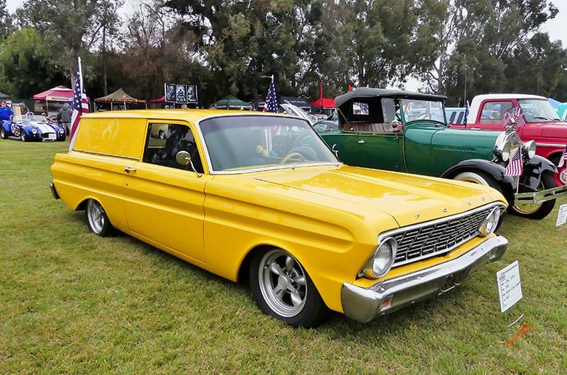Front profile of yellow classic Ford on the grass