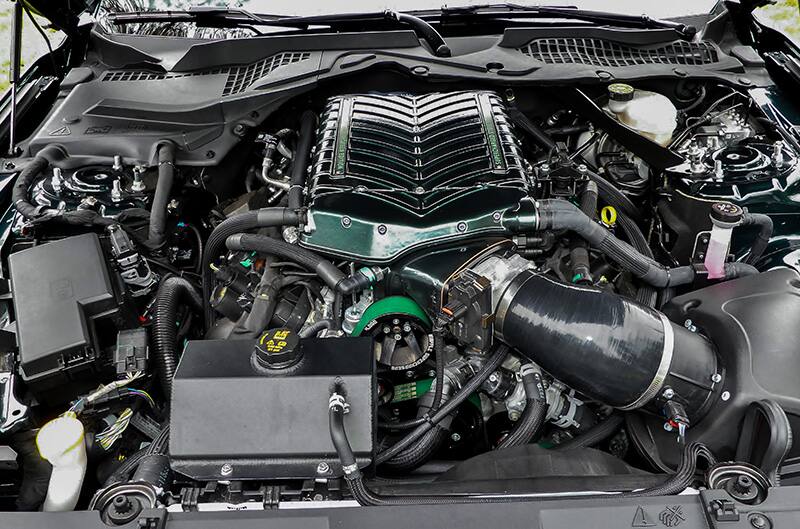 Close up of engine under the hood of the green Mustang