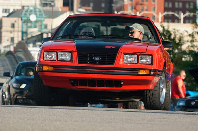 Close up front of a red GT on the road