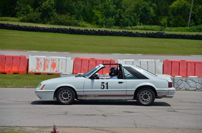 Profile of white Shelby Mustang on the track