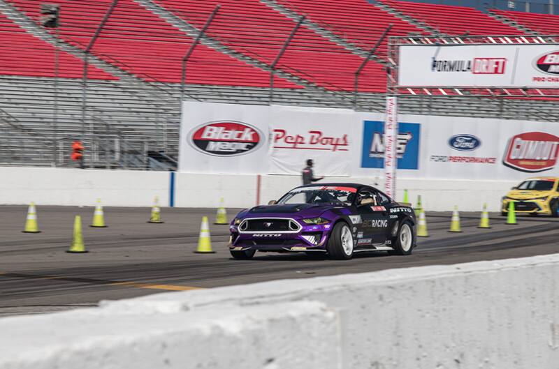 Front of Chelsea DeNofas black Mustang on the track