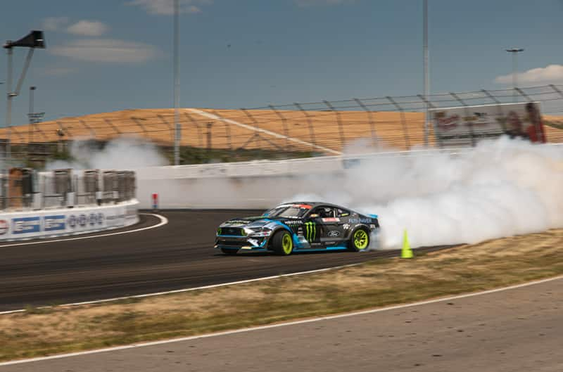 Front profile of Vaughn Gittin Jr black Monster Energy Fun Haver Mustang drifting on the track