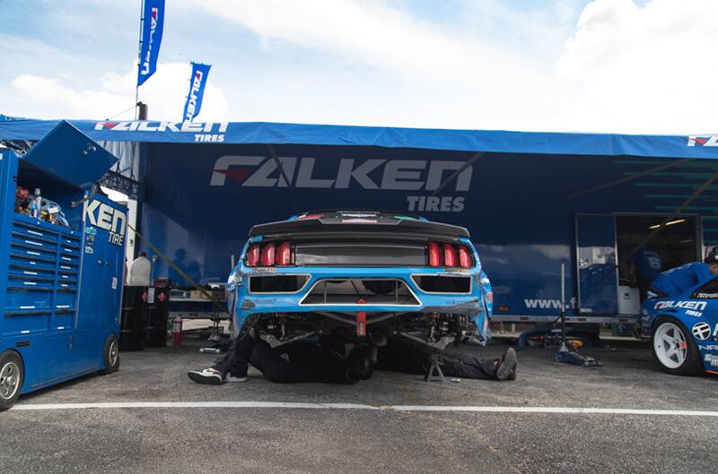 Rear of blue Mustang being worked on