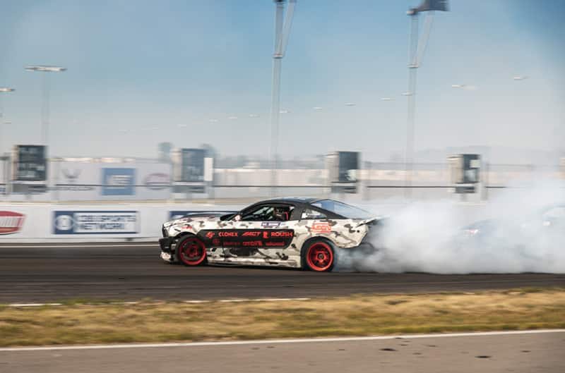 Profile of white gray and black camoflouge Mustang on the track