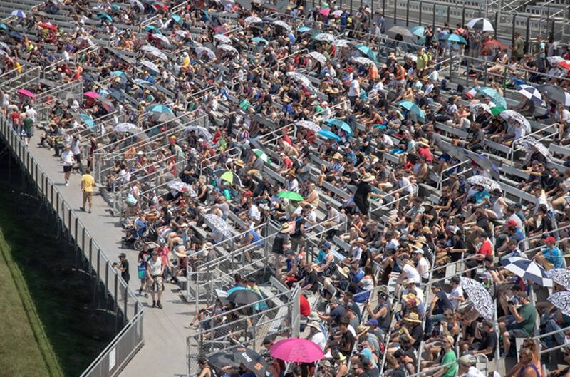 A crowd of people in the stands at the track