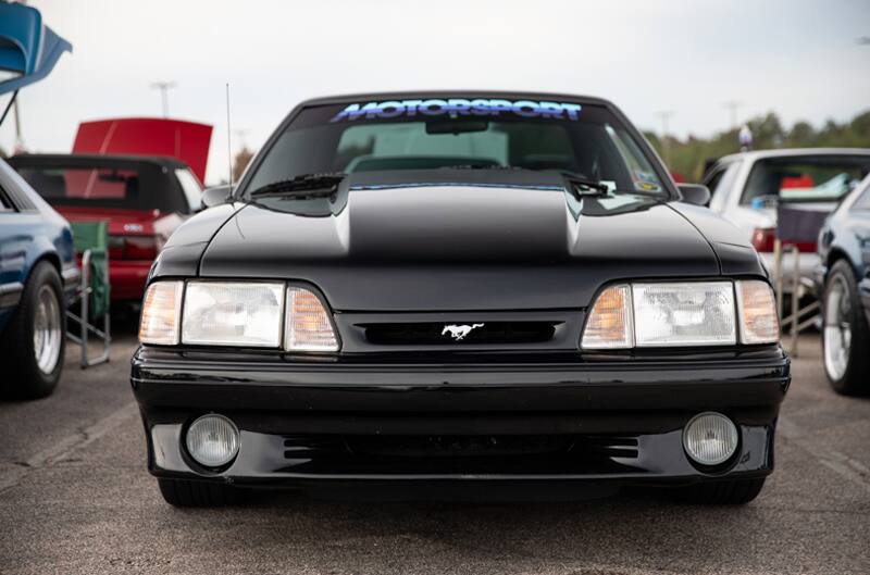 Close up front of black Mustang with Motorsport sticker on top of windshield