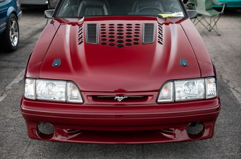 Close up front of red Mustang in parking lot