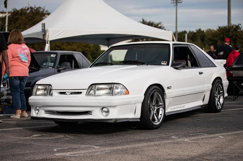 Front profile of white Mustang GT in parking lot