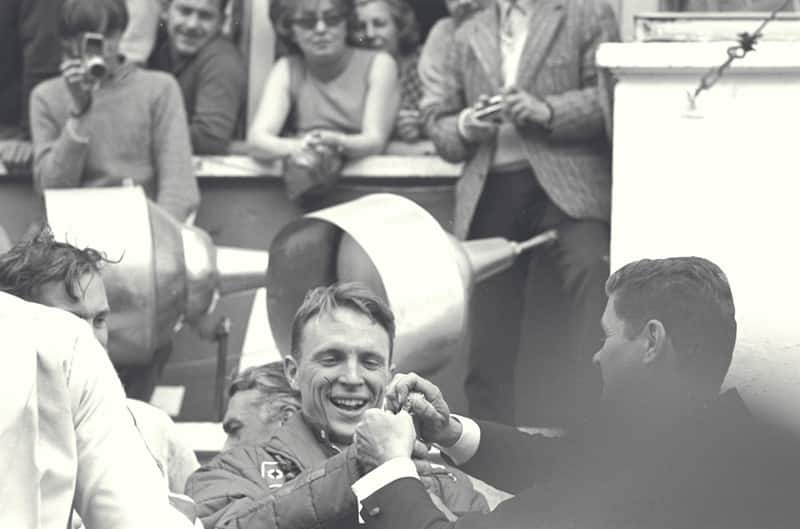 Black and white photo of Dan Gurney celebrating