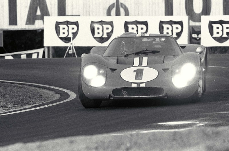 Black and white photo of front close up of GT driving on the track