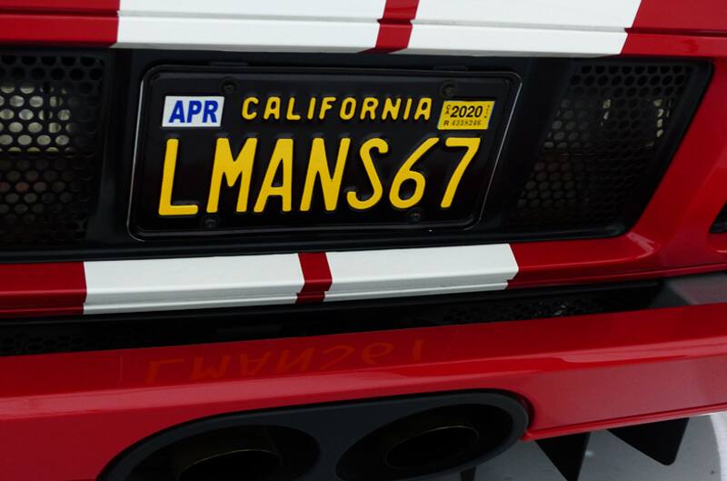 Close up of California license plate on back of the red GT