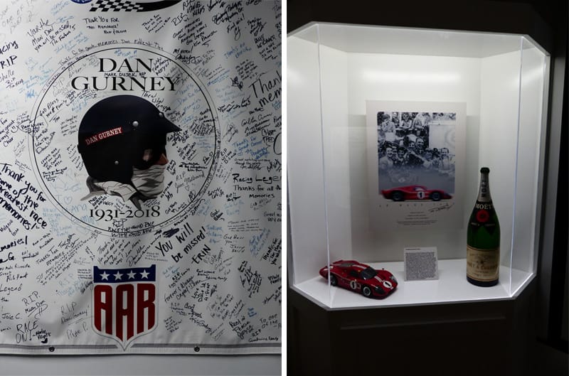 Side by side photos of a Dan Gurney flag with signatures and a display case with a bottle of champagne a mini red GT40 and a GT40 poster