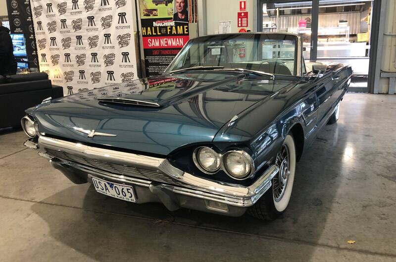 Front of blue Thunderbird with roof down at car show