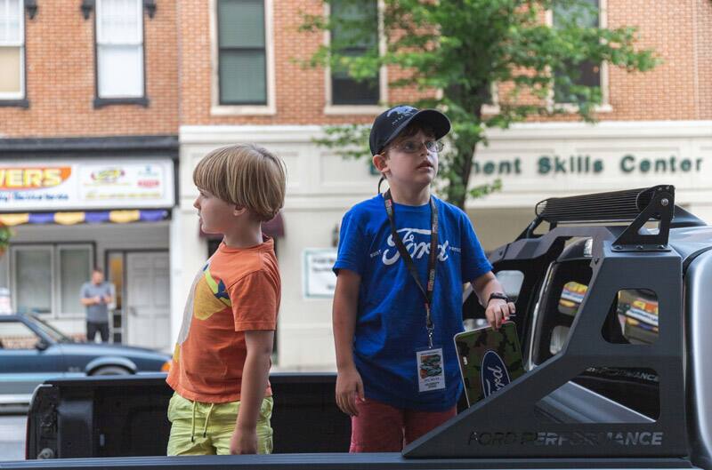 Patch Hurty and his younger brother in the trunk of a Ford Performance truck