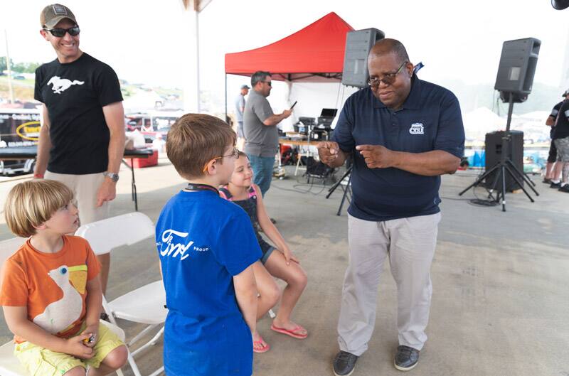 Patch Hurty talking to man with his dad younger brother and sister with him