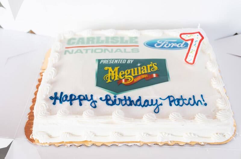 A cake that reads Happy Birthday Patch with a Ford logo and Carlisle Nationals painted on