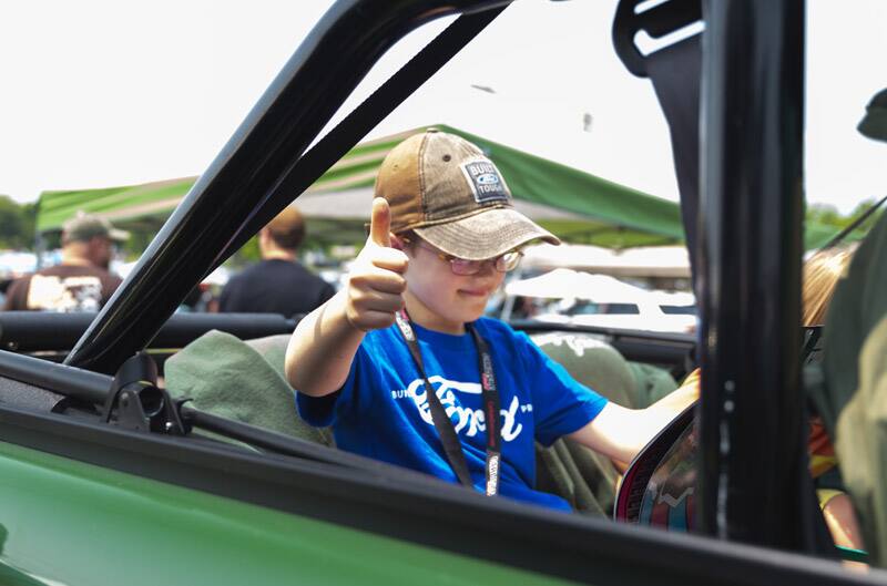 Patch Hurty sitting int the front seat of a Ford vehicle giving a thumbs up