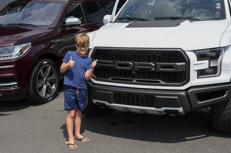 Patch Hurty posing in front of a white Ford truck