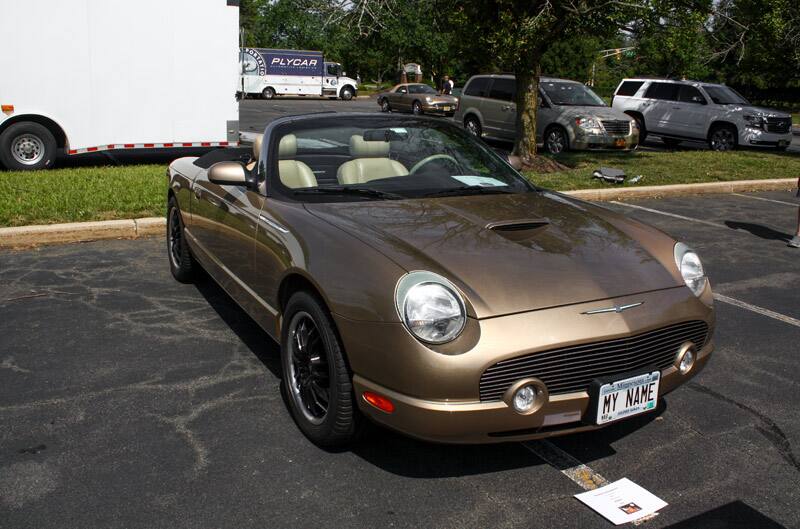 Front of brown Thunderbird Baby Bird with roof down in parking lot